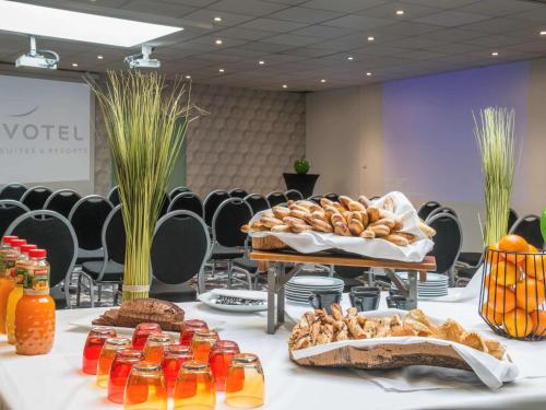 a table with bread and other food on it at Novotel Marseille Centre Prado Vélodrome in Marseille