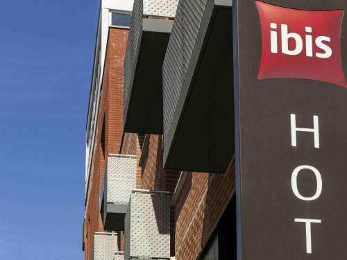 a building with aubs sign next to a hospital at ibis Lille Centre Grand Palais in Lille