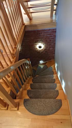a set of stairs in a room with a brick wall at BASTÓWKA 2 Apartamenty in Ustroń