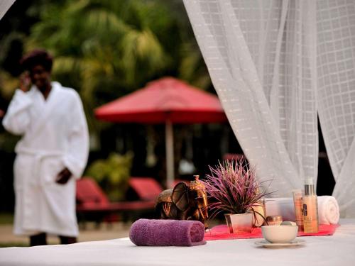 a table with a purple towel on top of it at Pullman Lubumbashi Grand Karavia. in Lubumbashi