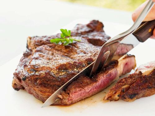 a steak on a plate with a knife and fork at ibis Sens in Sens