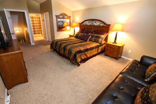 a bedroom with a bed and a couch at 217 Legacy Park in Davenport