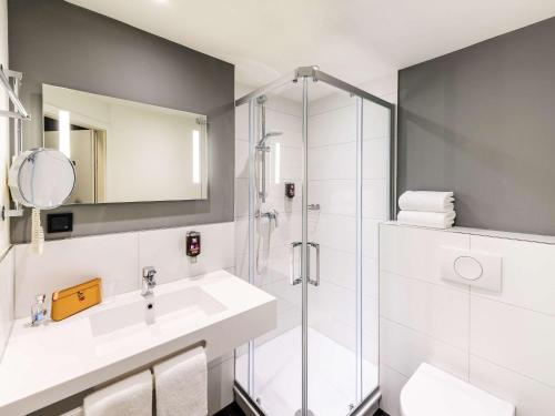 a bathroom with a sink and a shower at ibis Styles Halle in Halle an der Saale