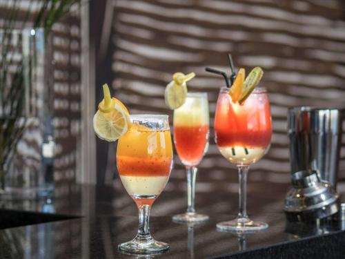 a group of four cocktails in wine glasses on a table at ibis Calama in Calama