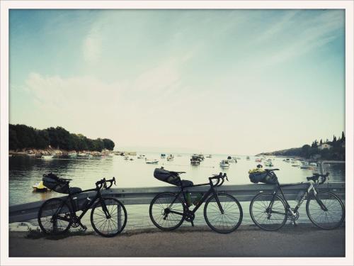 a group of bikes parked next to a body of water at House 61 Sveta Marina in Sveta Marina