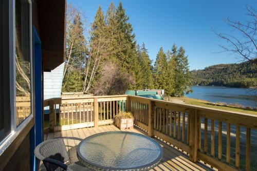 a balcony with a table and chairs and a view of a lake at Backeddy Resort and Marina in Egmont