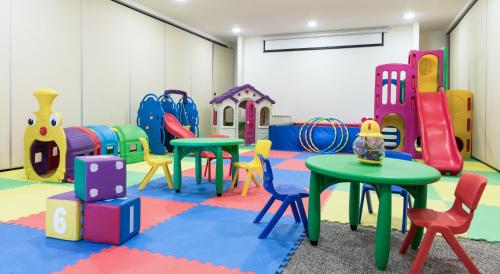 a room with tables and chairs in a play room at Río Serrano Hotel + Spa in Torres del Paine