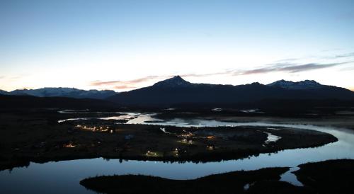 an aerial view of a lake at sunset at Río Serrano Hotel + Spa in Torres del Paine