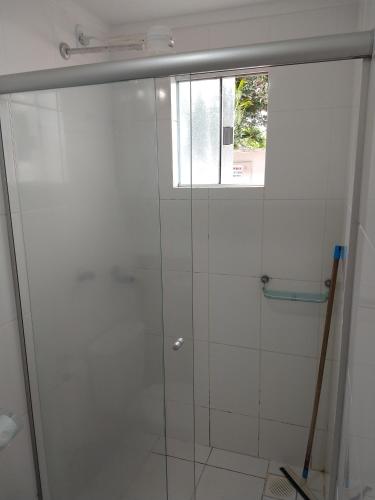 a shower with a glass door and a window at Lacqua diRoma 1 - Apartamentos JN in Caldas Novas