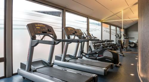 a row of tread machines in a gym at Río Serrano Hotel + Spa in Torres del Paine
