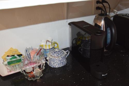 a counter top with a coffee maker and some cups at Beverly Hills Celebrity Home in Los Angeles