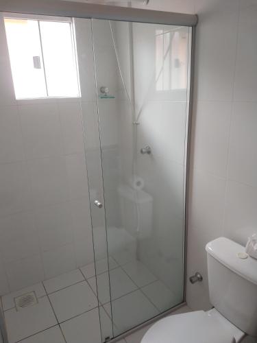 a shower with a glass door in a bathroom at Lacqua diRoma 1 - Apartamentos JN in Caldas Novas