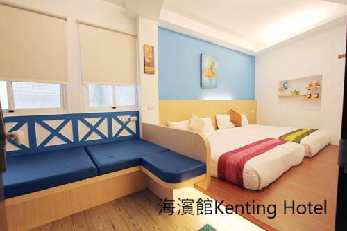 a bedroom with a bed and a blue bench at Kenting Hostel in Kenting