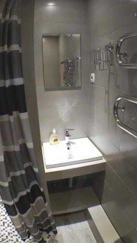 a bathroom with a sink and a mirror at Двухкомнатный люкс центр Металлургов 19 KR Apartments in Kryvyi Rih