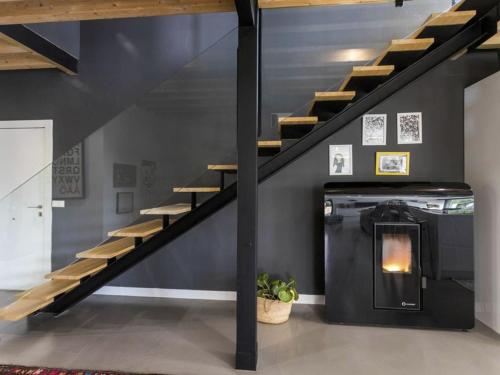 a living room with a staircase and a fireplace at Luxury Villa Beach & Golf in San Juan de Alicante