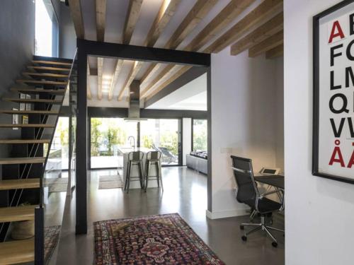 a living room with a staircase and a table and chairs at Luxury Villa Beach & Golf in San Juan de Alicante
