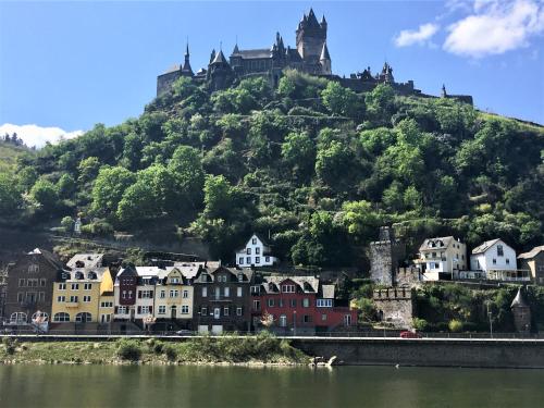 a town on a hill with a castle on top of it at Ferienhaus Maja in Cochem