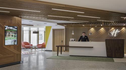 a man standing at a counter in an office lobby at Holiday Inn Istanbul Old City, an IHG Hotel in Istanbul