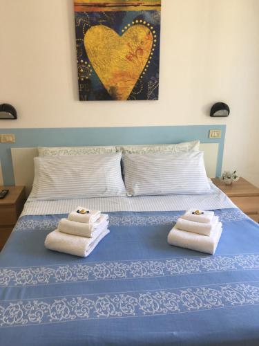 A bed or beds in a room at Hotel Villa Rinaldini