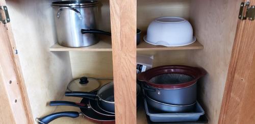 a wooden shelf with pots and pans in a kitchen at Lewis & Clark Resort in Yankton