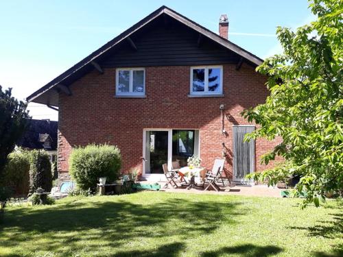a brick house with a lawn in front of it at Bed vue sur vallée de la Meuse Namur in Bouge