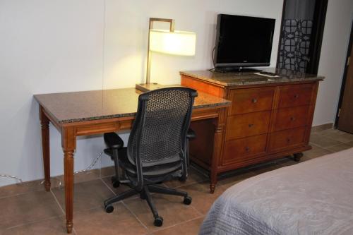 a desk with a television and a chair in a room at Lewis & Clark Resort in Yankton