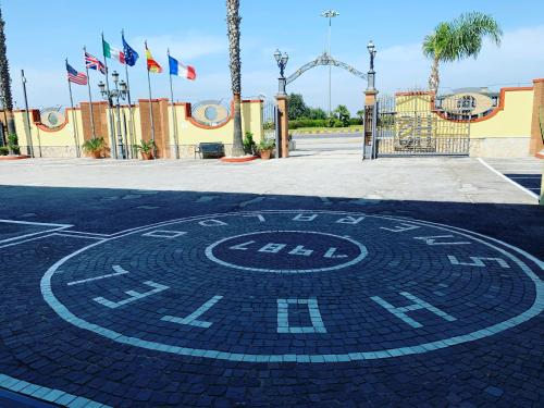 a clock on the ground in front of a roller coaster at Hotel Smeraldo in Qualiano