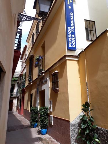 a building with a blue sign on the side of it at Pension Doña Trinidad in Seville