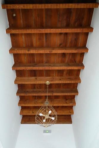 a chandelier hanging from a wooden ceiling at Hospederia Santa Clara in Utrera