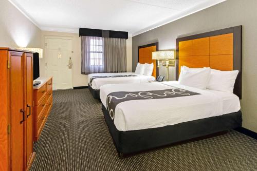 a hotel room with two beds and a bathroom at La Quinta Inn by Wyndham Santa Fe in Santa Fe