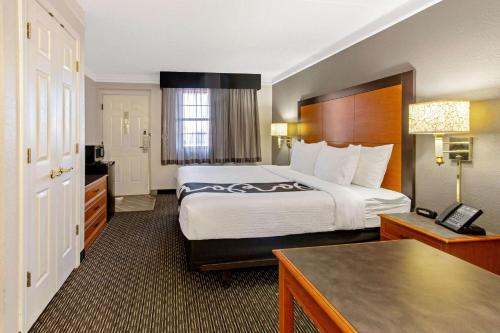 a hotel room with a large bed and a desk at La Quinta Inn by Wyndham Santa Fe in Santa Fe