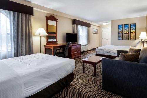 a hotel room with a bed and a desk at La Quinta Inn by Wyndham Sandusky near Cedar Point in Sandusky