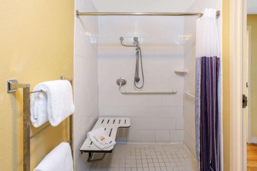 a small bathroom with a shower and a toilet at La Quinta by Wyndham Sarasota Downtown in Sarasota