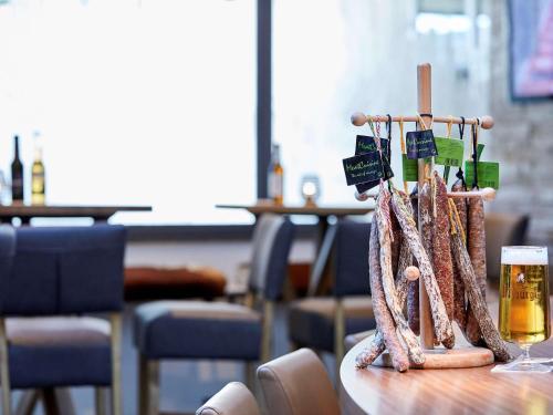 a table with a rack of food and a glass of beer at Mercure Tagungs- & Landhotel Krefeld in Krefeld
