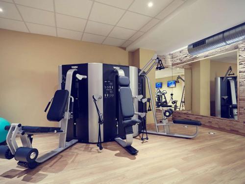 a gym with cardio equipment in a room at Mercure Tagungs- & Landhotel Krefeld in Krefeld