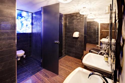 a bathroom with a sink and a toilet at M Hotel Sosnowiec in Sosnowiec