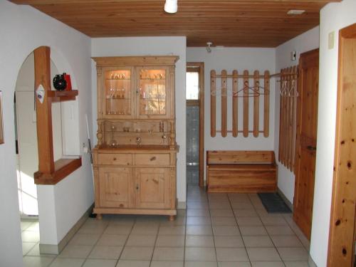 a room with a wooden cabinet in a room with a hallway at Ferienwohnung Gadenstatt in Davos