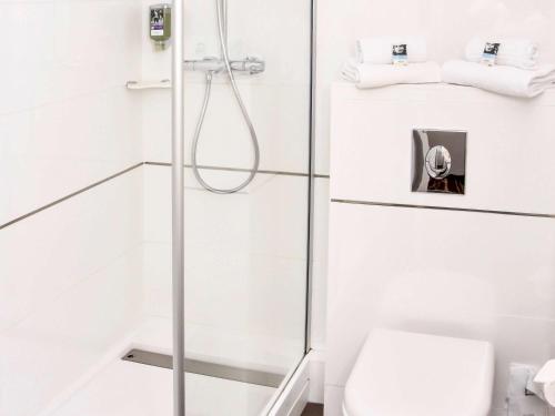 a bathroom with a shower with a toilet at Mercure Granville Le Grand Large in Granville
