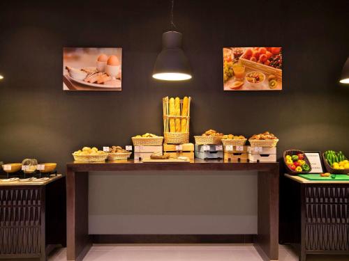 a buffet with food on a table in a restaurant at ibis Dubai Al Rigga in Dubai