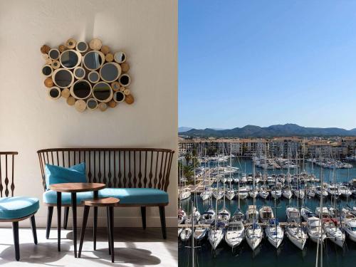 a dining room with a view of a marina at Mercure Thalasso & Spa Port Fréjus in Fréjus