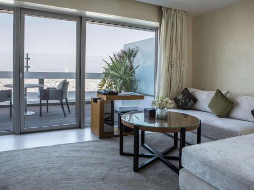 a living room with a couch and a table at Sofitel Casablanca Tour Blanche in Casablanca