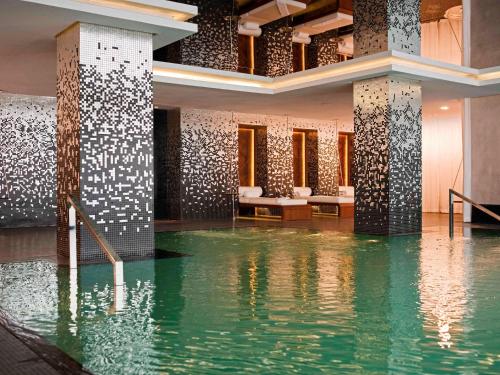 a room with a pool of water in a building at Sofitel Casablanca Tour Blanche in Casablanca