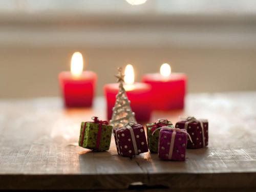 a group of christmas presents and candles on a table at Novotel Edinburgh Park in Edinburgh