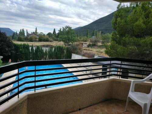 a view of a swimming pool on a balcony at Tena Biescas Tourist Home in Biescas