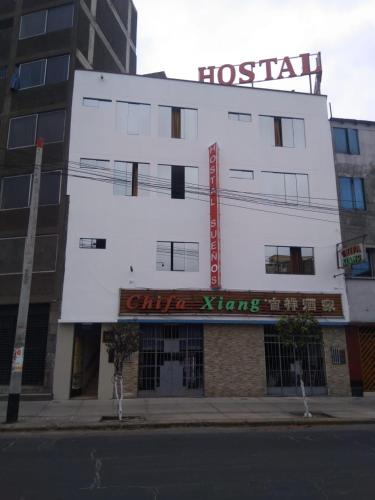 a building with a sign for a hotel at Hostal Sueños Breña in Lima