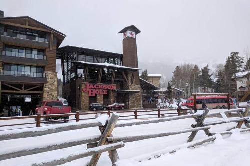 a building with a clock tower in the snow at Beautiful Mountain Condo in Wilson