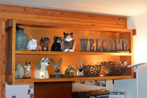 a shelf with figurines of cats and rabbits on it at Beautiful Mountain Condo in Wilson