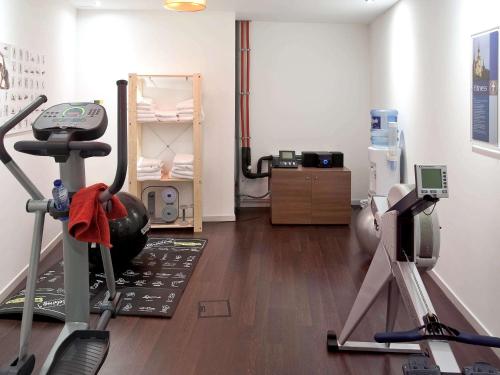 a room with a gym with a treadmill at Aparthotel Adagio Brussels Grand Place in Brussels