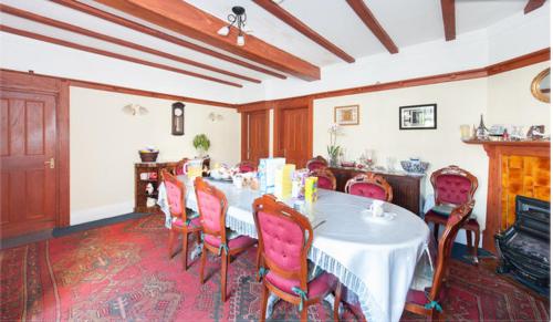 una sala da pranzo con tavolo e sedie bianchi di Saint Gabriel's Road Guesthouse a Londra