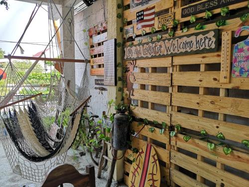 a wall with two hammocks and a sign on it at La Terraza Hostel in Flores
